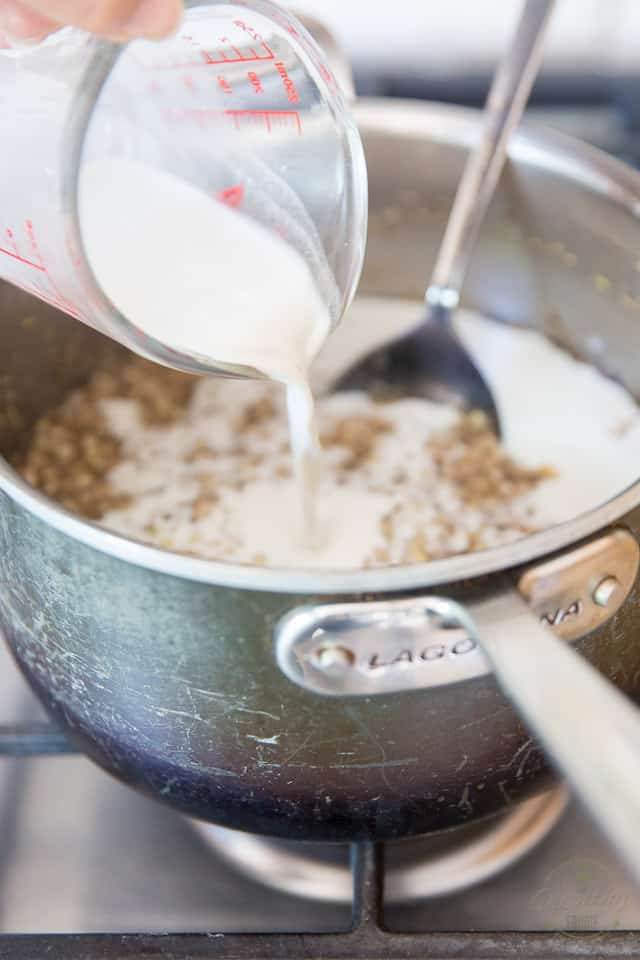 Pouring hemp milk into the saucpan with the cooked cereal in it
