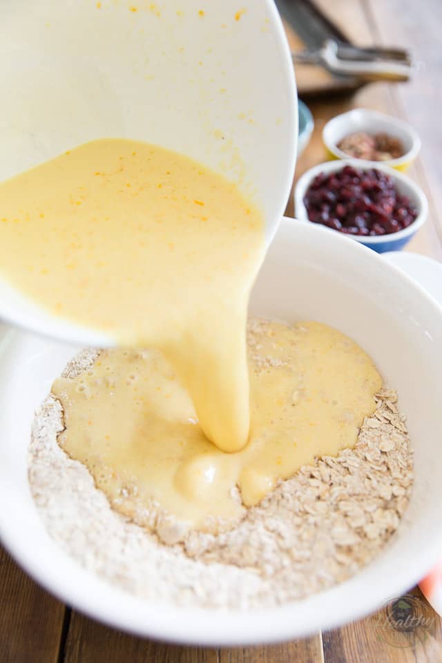 A mixture of eggs and milk is poured into a bowl containing flour and oats