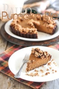 Paleo Pumpkin Pie heaven is here! A devilishly rich and spicy custard-like filling in a tender, crispy crust, topped with a crunchy honey sweetened crumble.