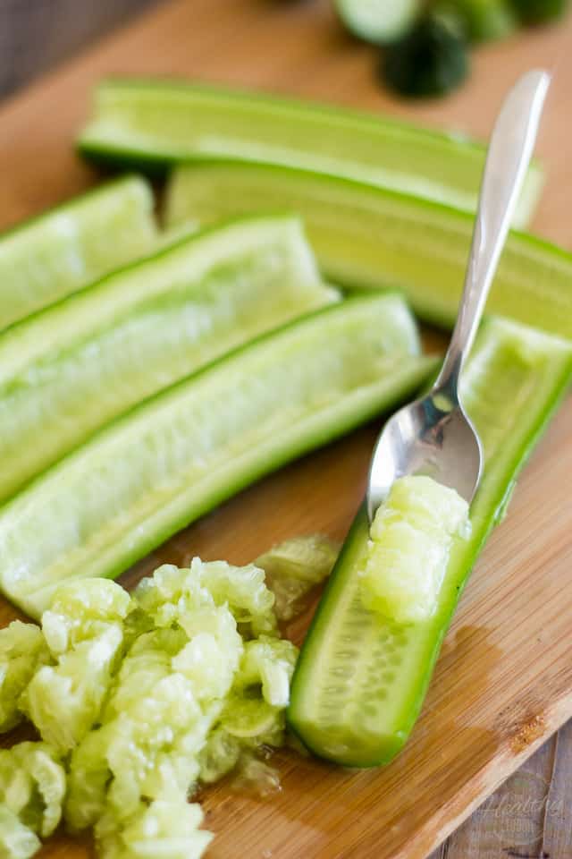 Lebanese cucumbers getting seeded with a spoon