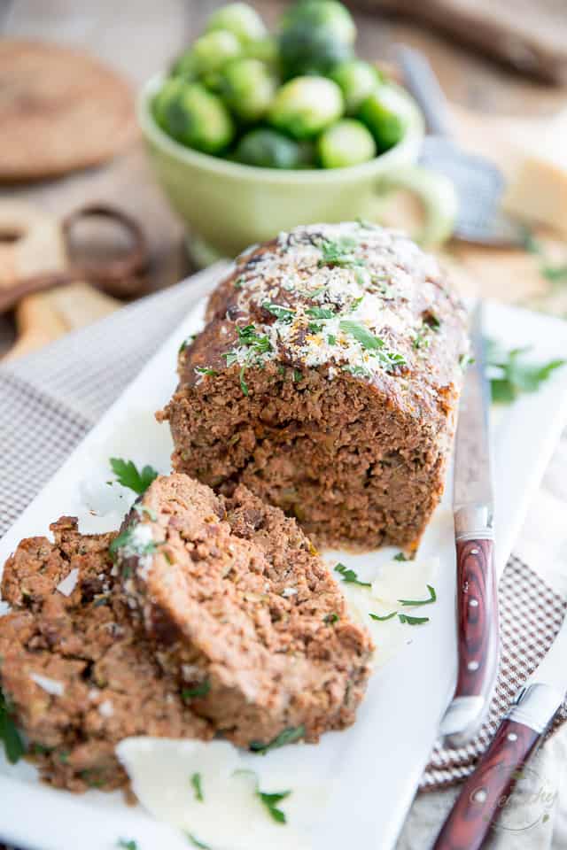 Grated zucchini, cheese and sun dried tomatoes make this Cheddar Parmesan Zucchini Meatloaf so moist and tasty, it will easily become a family favorite! 