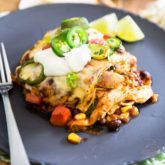 Chicken, corn, black beans, cheese and flour tortillas in a spicy enchilada sauce, healthy has never felt so indulgent as this Chicken Enchilada Casserole.