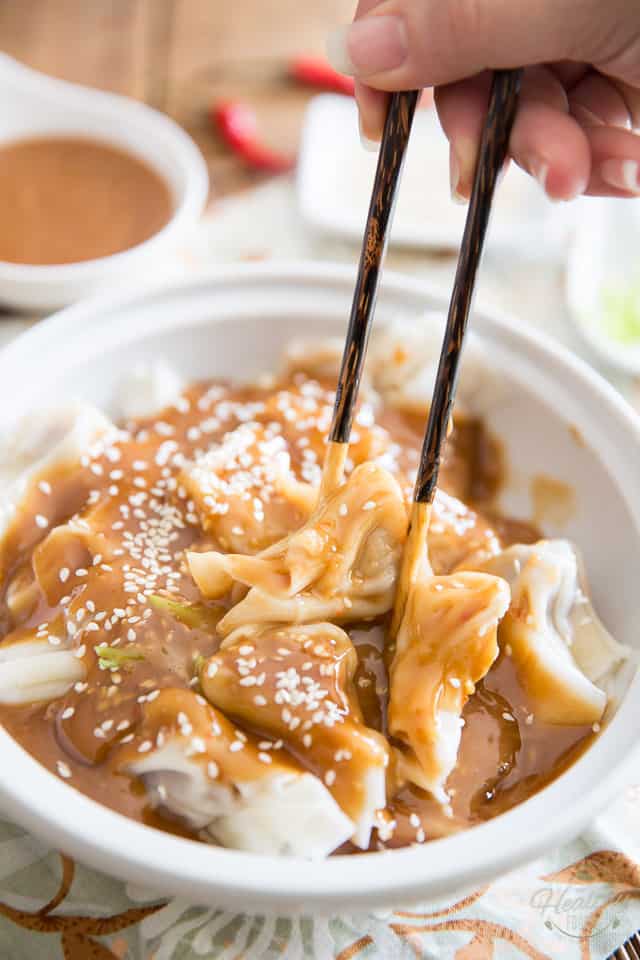 Hunan Dumplings are meat filled wontons generously covered in a sweet and spicy peanut butter sauce. A favorite in Quebec, they'll no doubt win your heart!
