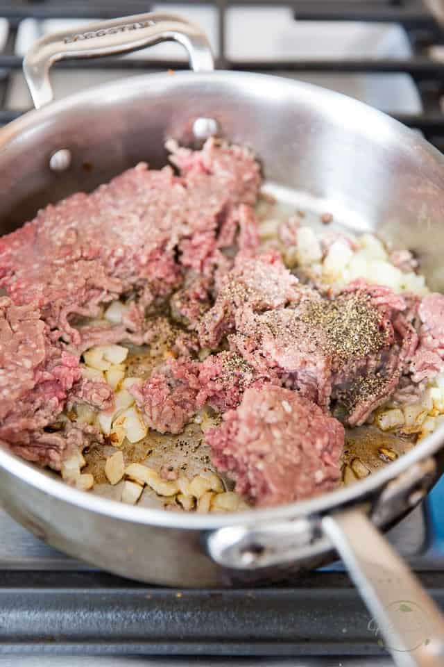 Ground Lamb gets browned in a saute pan with onions and garlic