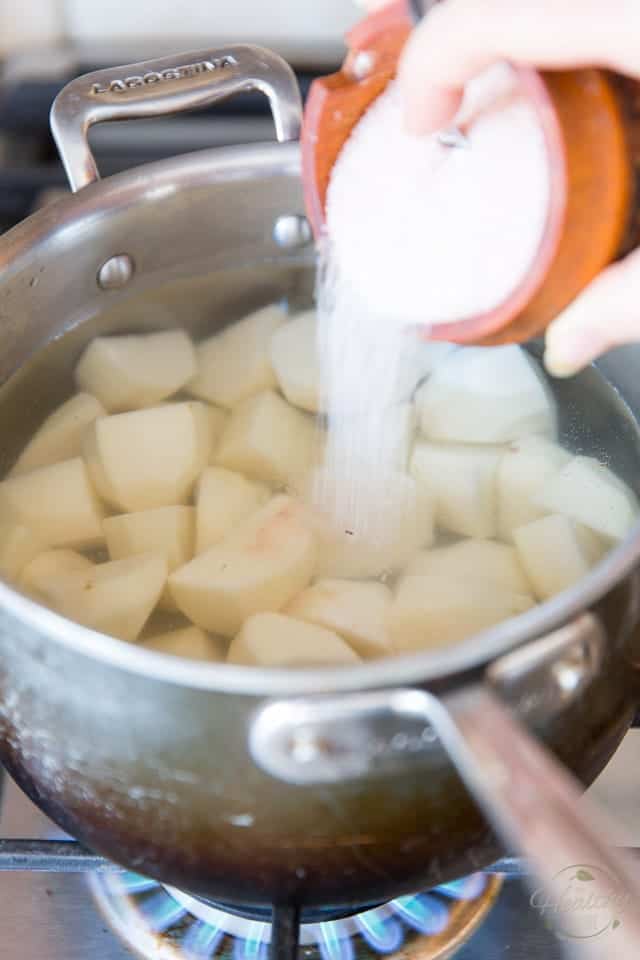 Adding lots of salt to the cold water the potatoes will cooking in