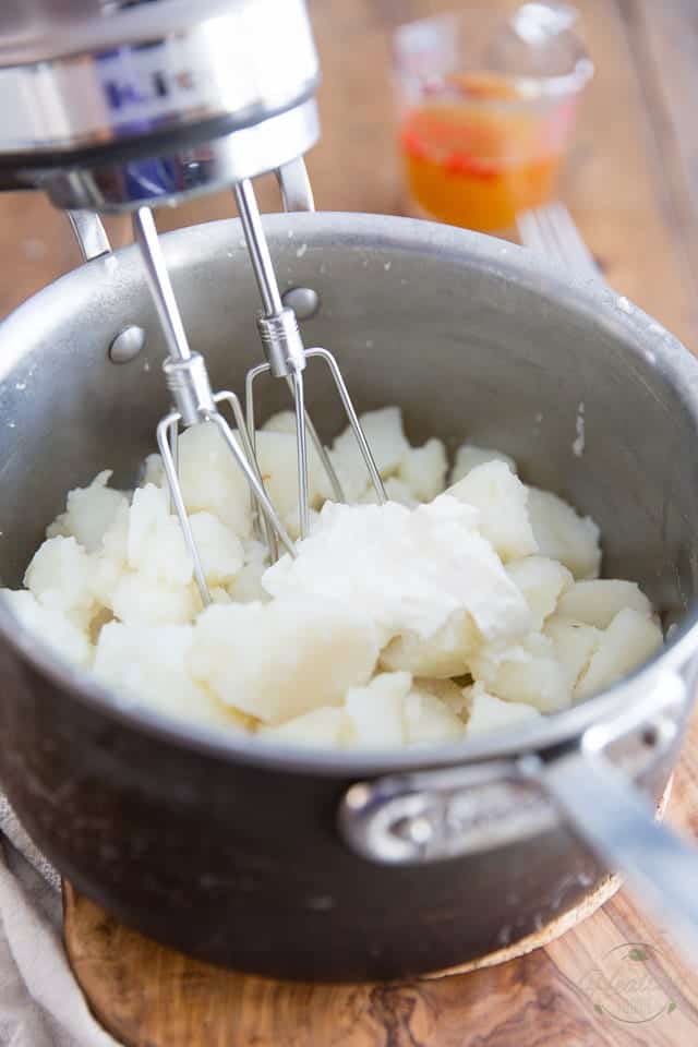 Potatoes have been returned to pot with sour cream and milk