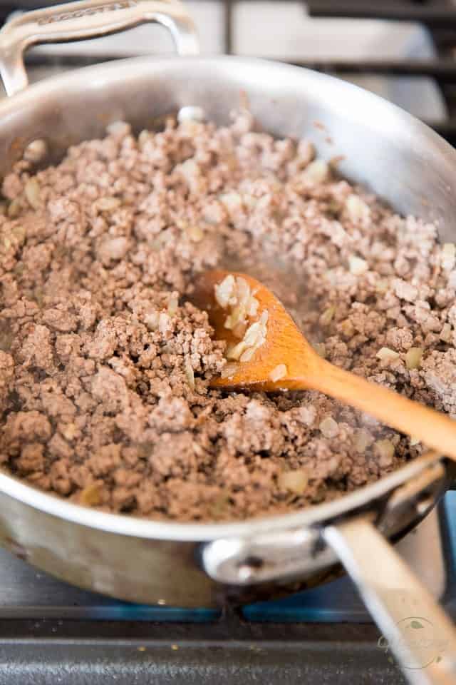 Cooking the ground lamb meat until it's completely brown