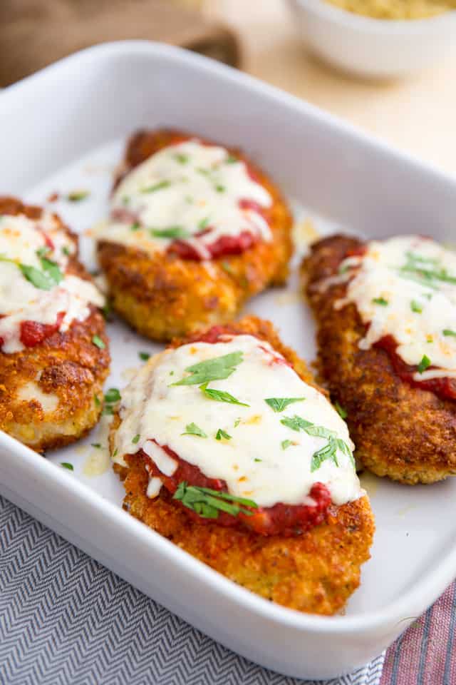 Cooked Chicken Parmigiana in white baking dish