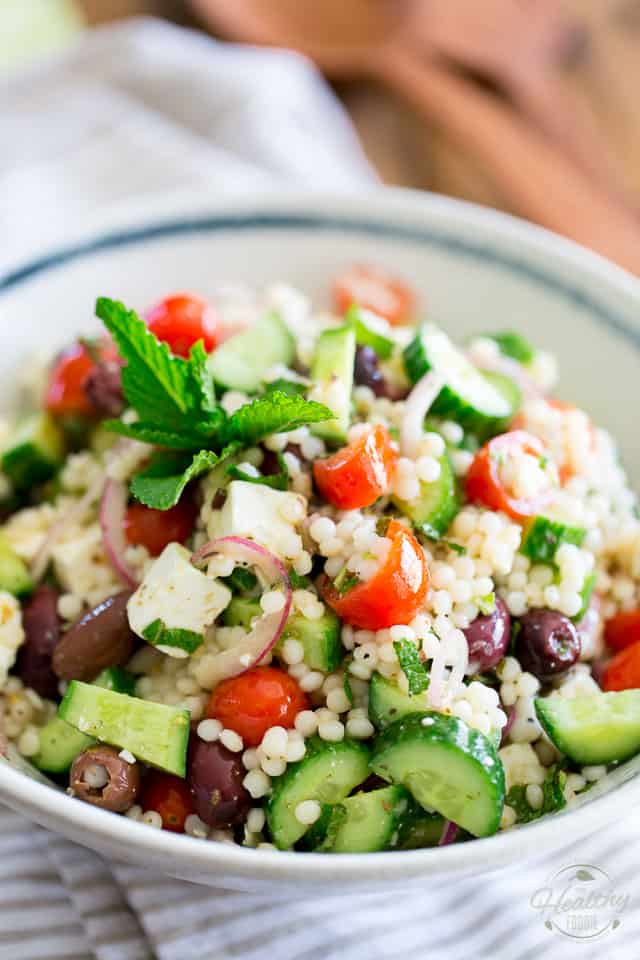 Loaded with tomatoes, cucumbers, feta cheese and kalamata olives, this Greek Style Pearl Couscous Salad is super refreshing, bursting with flavor and sure is a nice twist on your traditional Greek Salad! Bound to become a favorite this summer... 