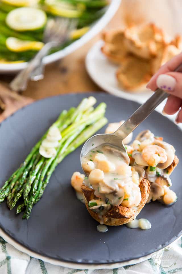 Rich and creamy Seafood Sauce getting spooned into Toast Cups