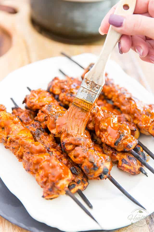 Buffalo Chicken Skewers fresh off the grill, getting brushed with more buffalo sauce