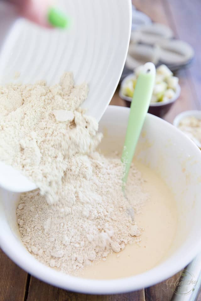 Flour mixture being added to wet ingredients to make muffin batter