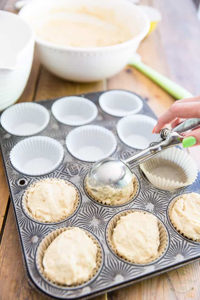 Muffin batter getting divided between cups of muffin pan