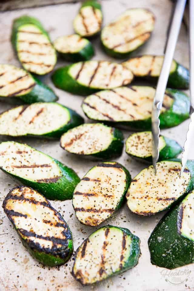 Grilled zucchini slices on a sheet pan