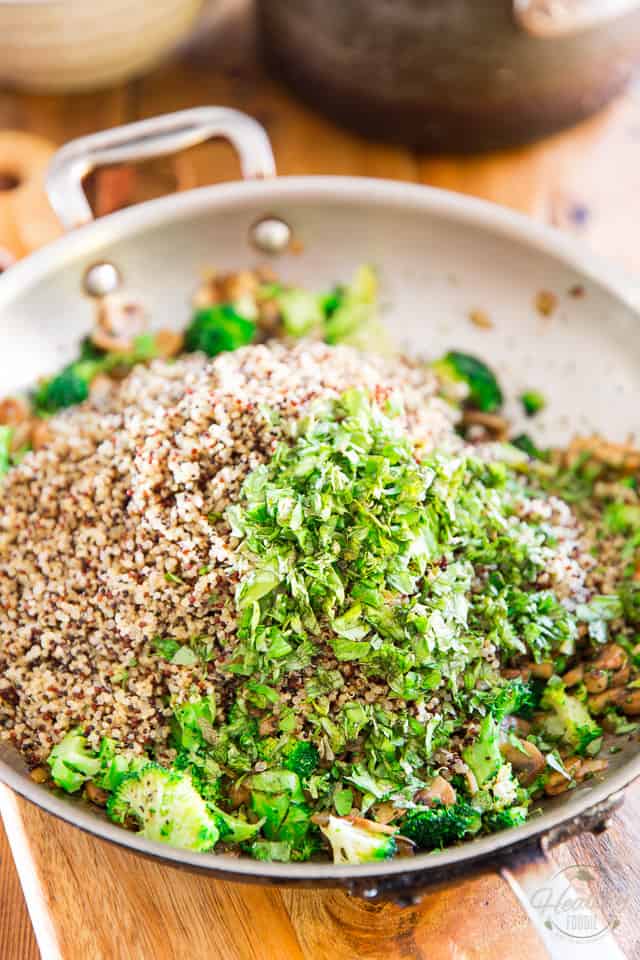 Quinoa broccoli mushrooms and basil in large stainless steel skillet