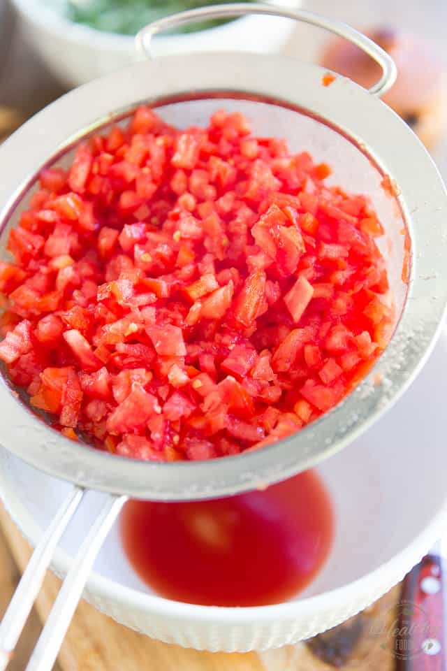 Finely diced tomatoes in a fine meshed sieve