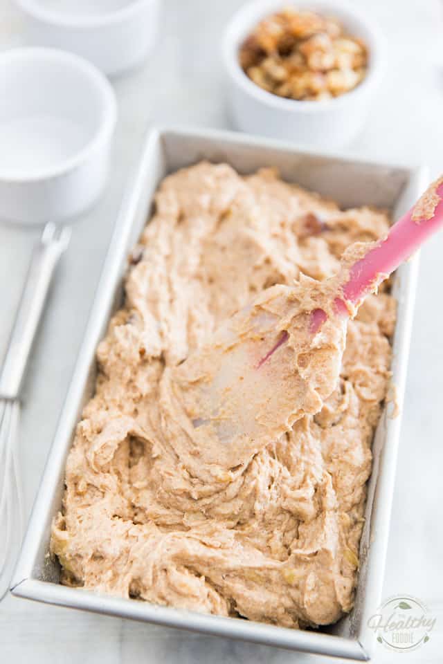 Transferring banana bread batter to loaf pan and spreading with rubber spatula