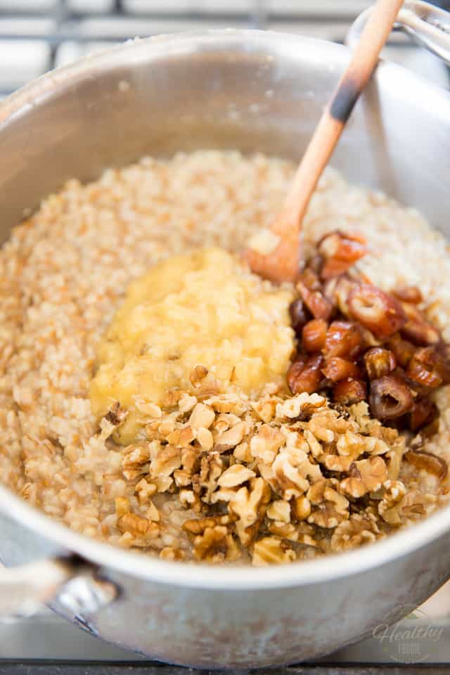 Adding mashed bananas, dates and walnuts to cooked oatmeal