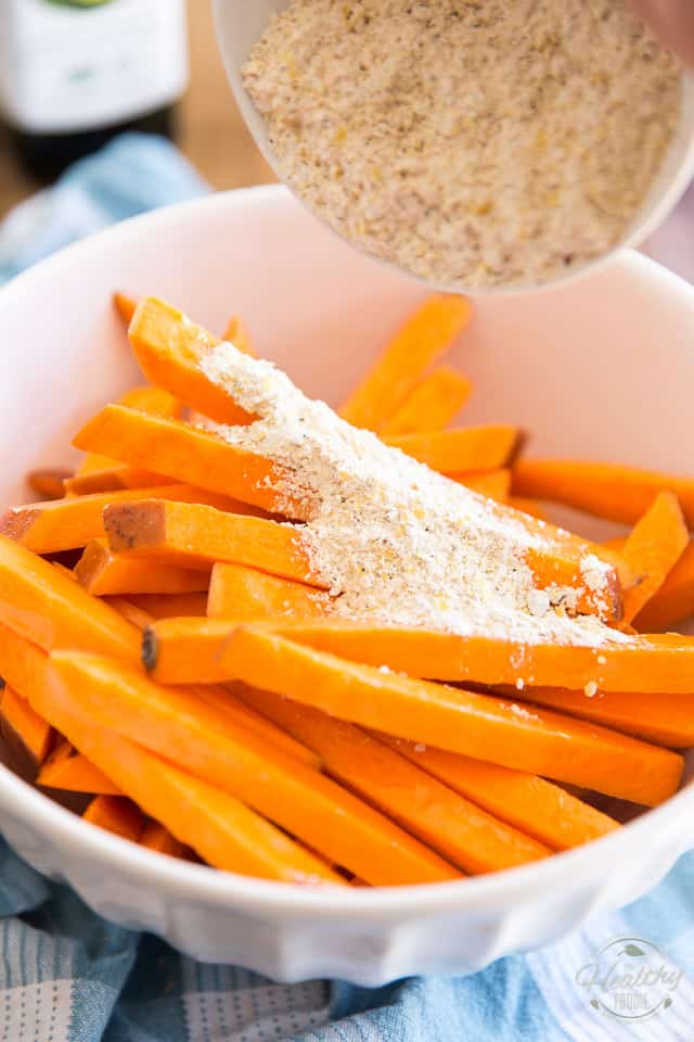 Adding the spice mixture to the sweet potato strips