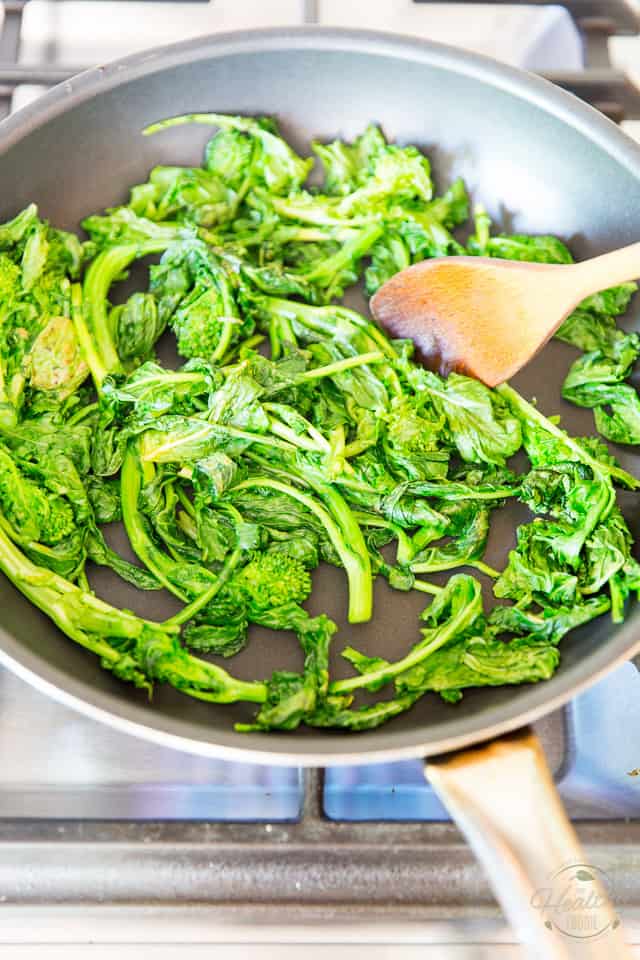 Cook the rapini until it's wilted and vibrant green