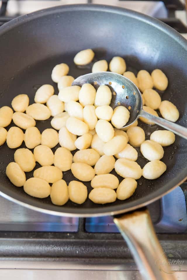 Add the cooked gnocchi to the hot frying pan