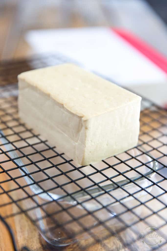 Place the tofu block onto a cooling rack set over a baking dish of some kind