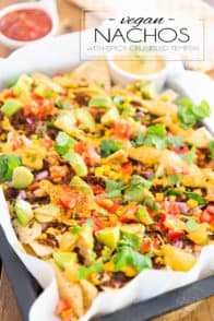 Spicy crumbled tempeh, loads of veggies and warm cashew queso scattered over a bed of organic corn tortilla chips... These Vegan Nachos with Spicy Crumbled Tempeh are the ultimate party food made good for you!