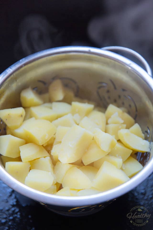 When the potatoes are cooked, drain them and give them a minute or two to dry out in the colander