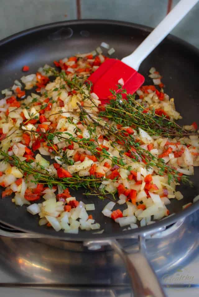 Add the chopped onion, garlic, bell pepper and thyme to the pan and cook for a few minutes