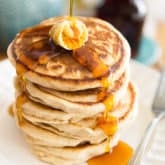 Quick and easy to make, these Light and Fluffy Vegan Pancakes are the ultimate comforting Sunday breakfast! Guaranteed to please everyone - no one will never know they're made with whole wheat flour!